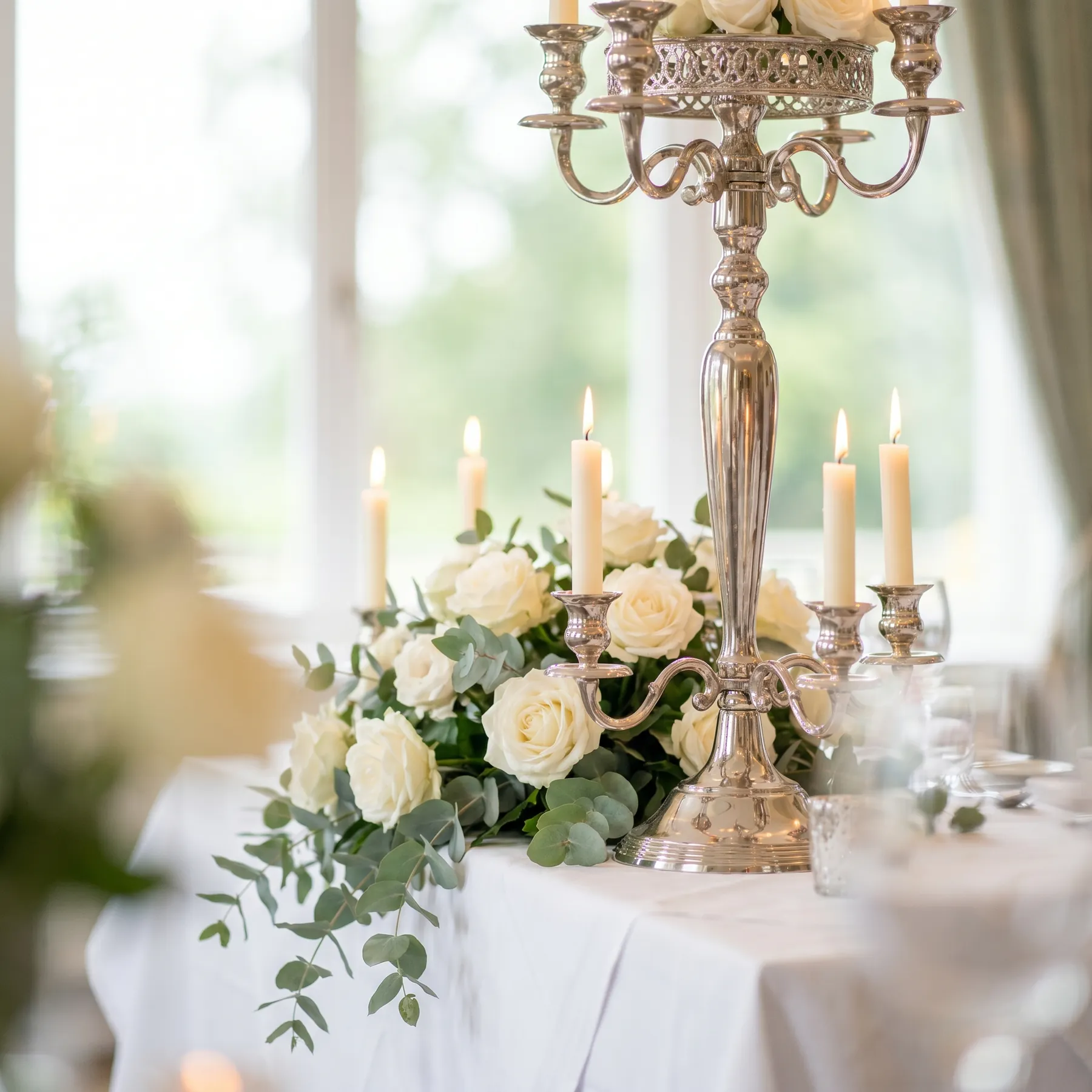 Silver candelabra centrepiece with roses