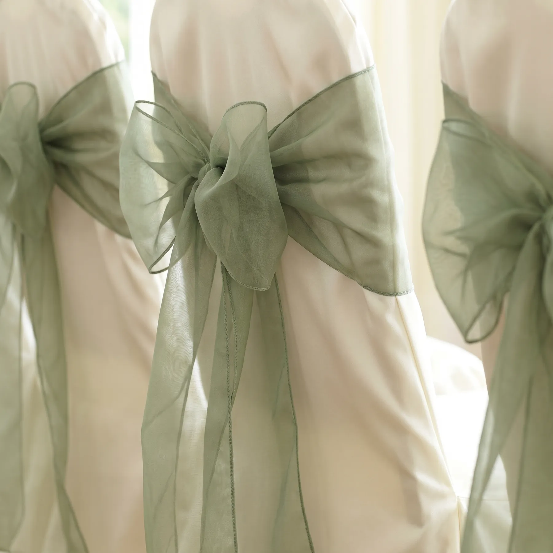 Sage organza sashes tied in bows